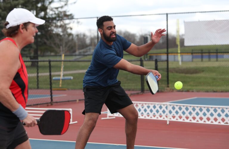 pickleball is being played outdoors by beginners