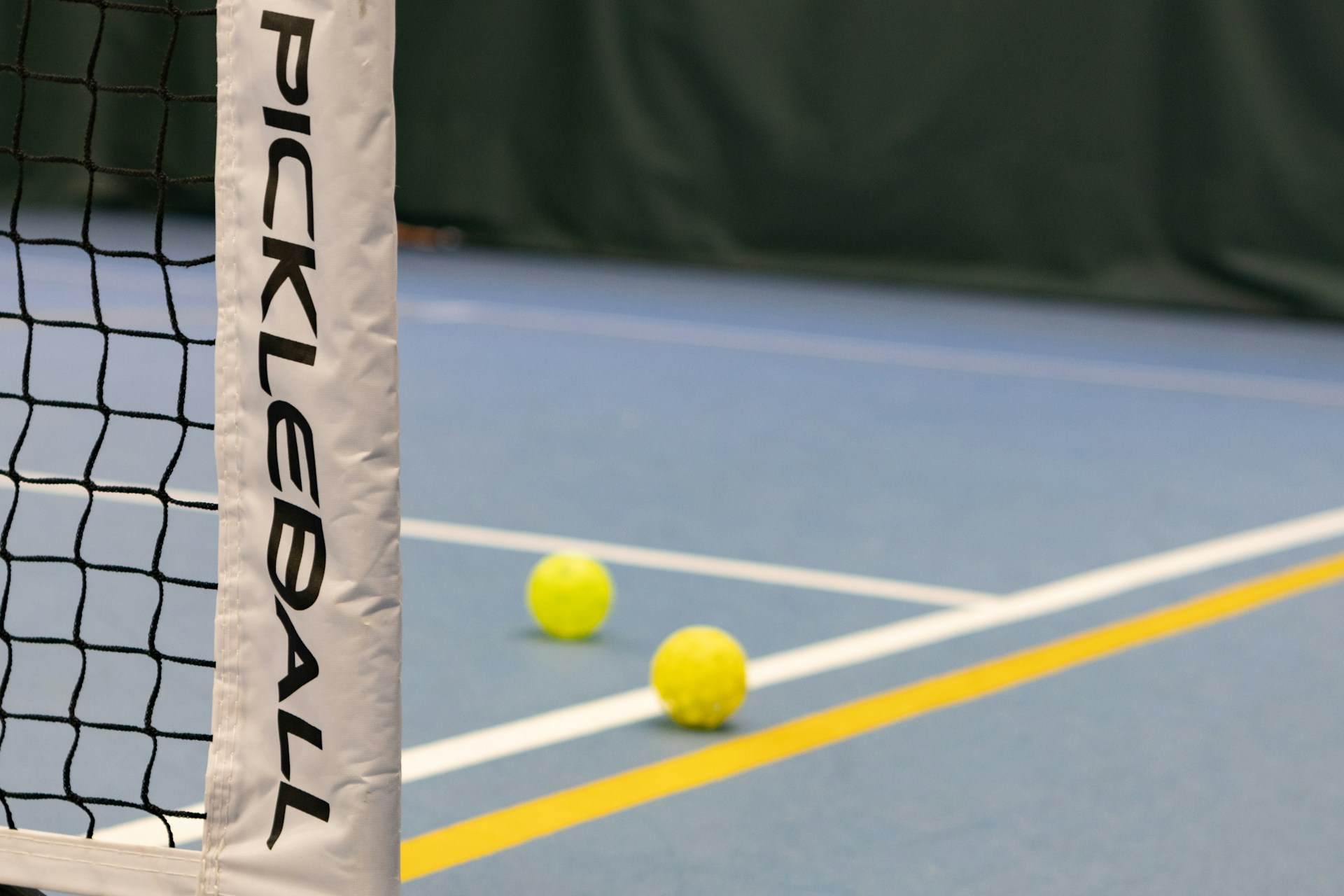 pickleball court with balls on the ground